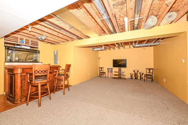 basement with carpet and indoor bar