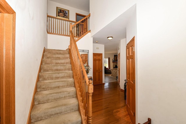 stairs featuring hardwood / wood-style flooring