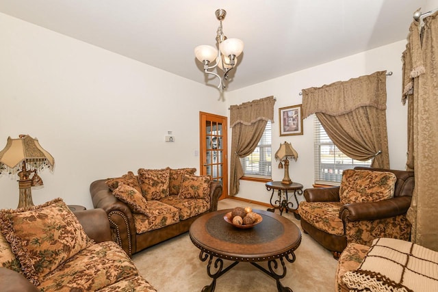 carpeted living room with a notable chandelier