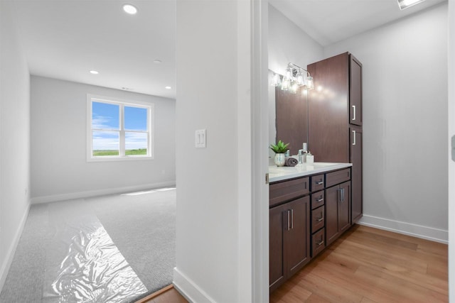 bathroom featuring hardwood / wood-style flooring and vanity