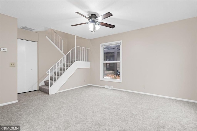 empty room featuring ceiling fan and carpet floors