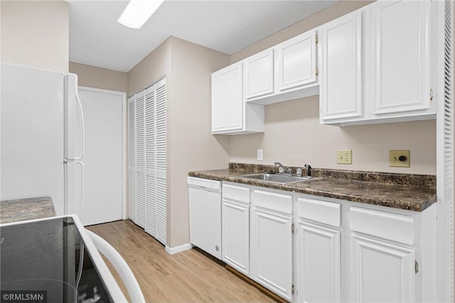 kitchen with sink, white cabinets, white appliances, and light wood-type flooring