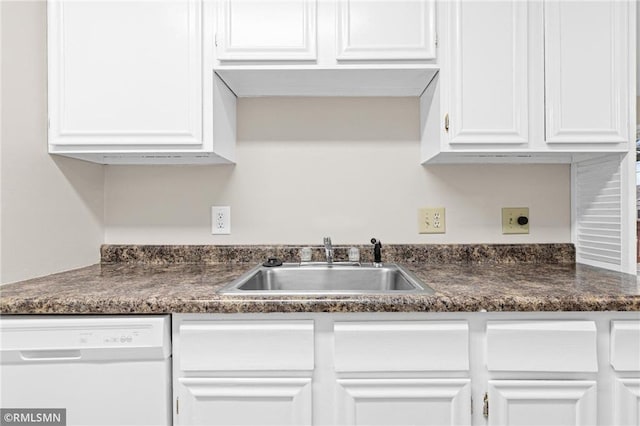 kitchen with dishwasher, white cabinetry, and sink