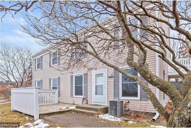 rear view of house with central AC unit