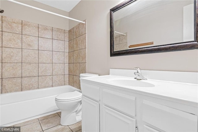 full bathroom featuring tile patterned floors, vanity, toilet, and tiled shower / bath