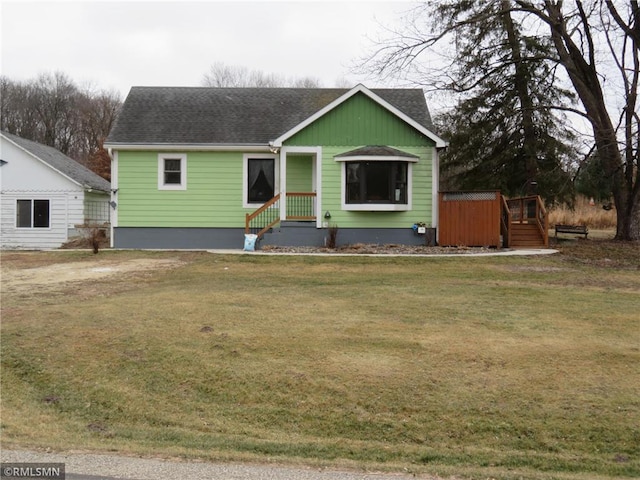 view of front of home with a hot tub and a front yard