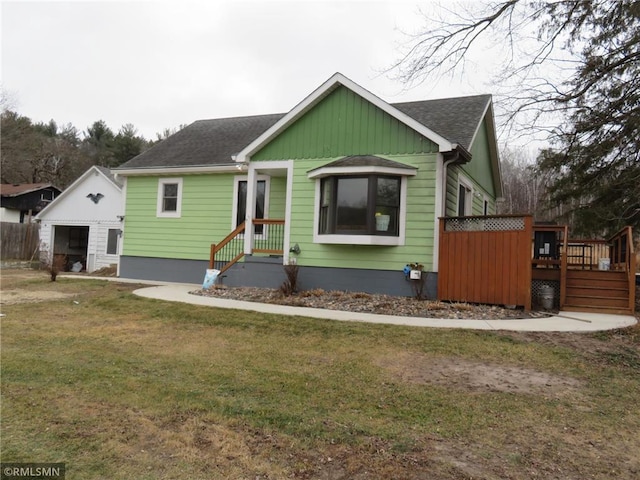 view of front of property with a front lawn and a wooden deck