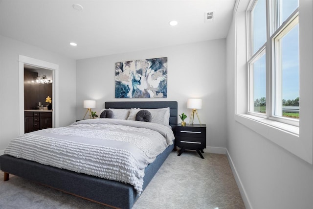 bedroom featuring carpet flooring and connected bathroom