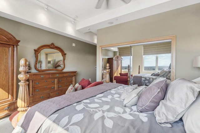 bedroom with rail lighting and ceiling fan