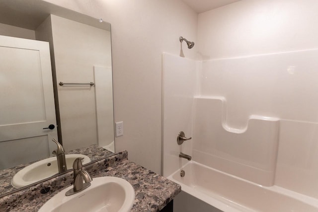 bathroom featuring bathing tub / shower combination and vanity