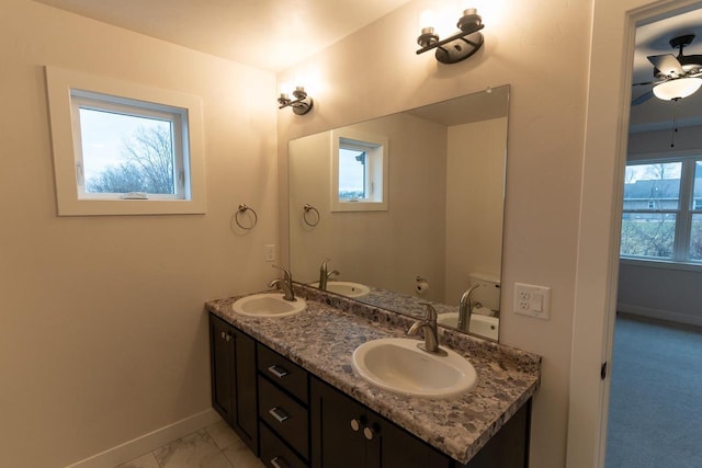 bathroom with ceiling fan, vanity, and toilet