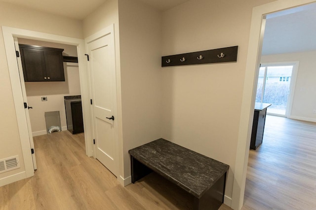 mudroom with light hardwood / wood-style floors