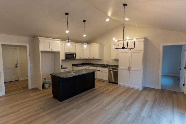 kitchen with sink, stainless steel appliances, light hardwood / wood-style floors, pendant lighting, and white cabinets