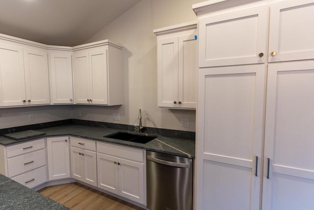 kitchen featuring stainless steel dishwasher, white cabinets, and sink