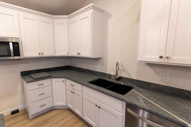 kitchen featuring white cabinets, stainless steel appliances, and sink