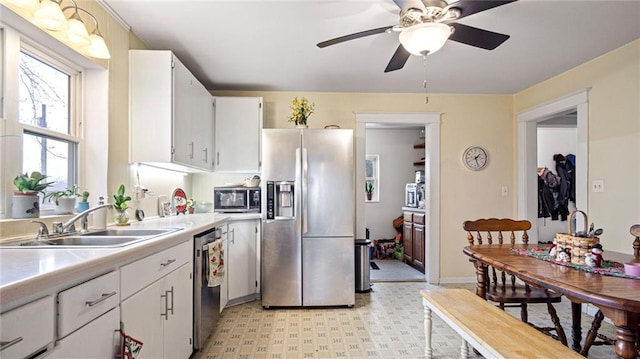 kitchen featuring white cabinets, appliances with stainless steel finishes, ceiling fan, and sink