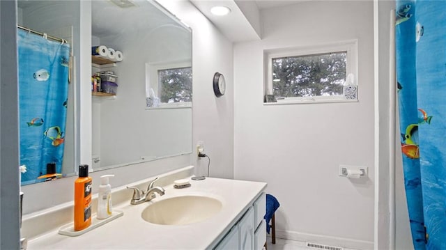 bathroom with tile patterned flooring, vanity, and curtained shower