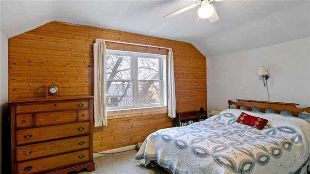 carpeted bedroom featuring ceiling fan, wood walls, and multiple windows