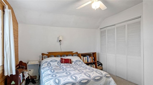 carpeted bedroom featuring a closet, lofted ceiling, and ceiling fan