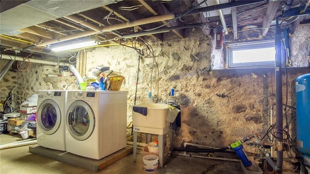 laundry area featuring independent washer and dryer and sink