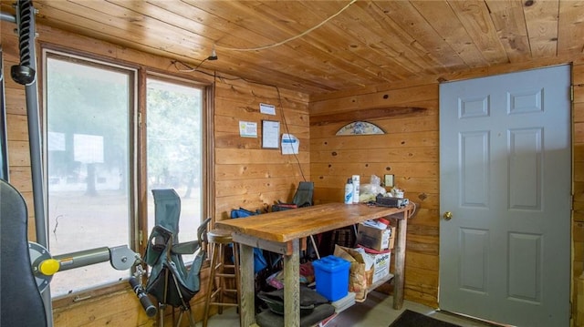 dining space featuring wooden walls and wood ceiling