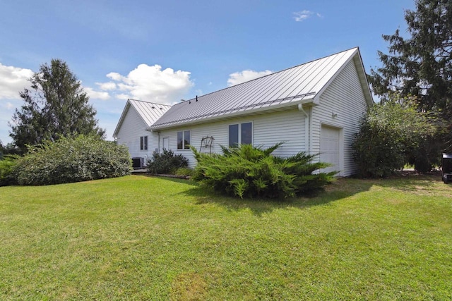 back of property with a yard and a garage