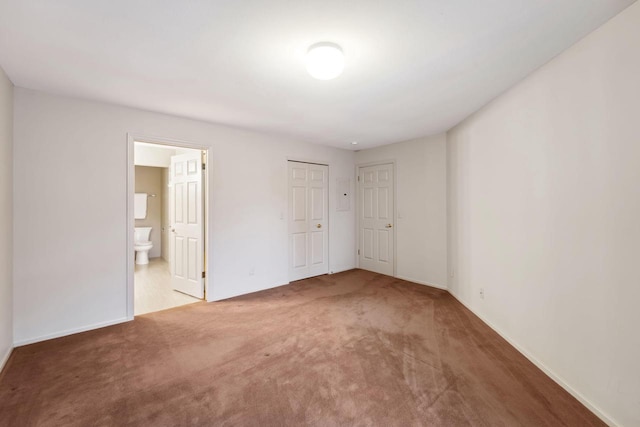 unfurnished bedroom with carpet floors and ensuite bath