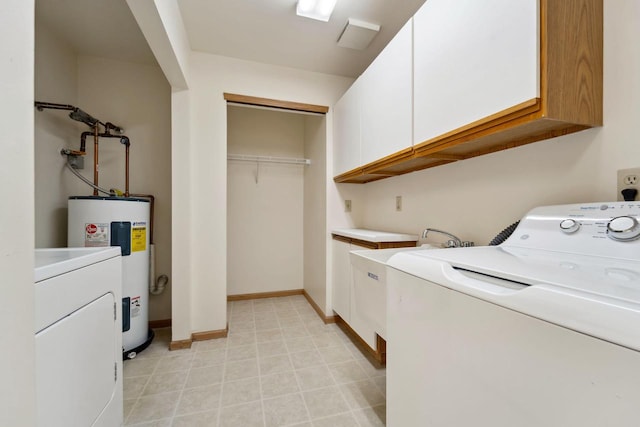 laundry area featuring cabinets, electric water heater, and washer / clothes dryer