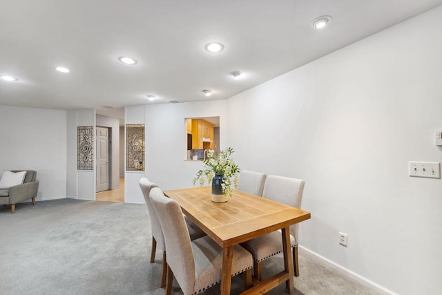 dining room featuring light carpet