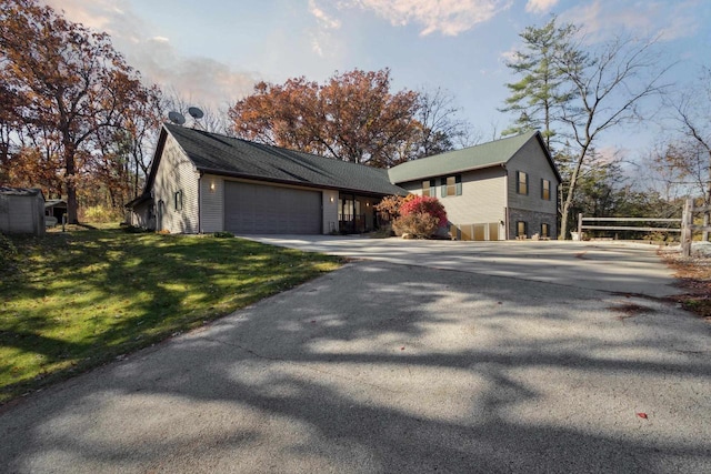 exterior space featuring a garage and a lawn