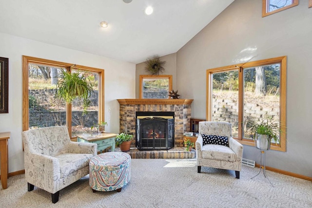 carpeted living room with a fireplace, plenty of natural light, and lofted ceiling