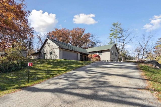 view of front of property featuring a garage and a front lawn