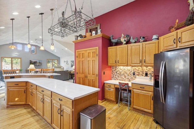 kitchen with a center island, hanging light fixtures, tasteful backsplash, light hardwood / wood-style floors, and stainless steel fridge with ice dispenser