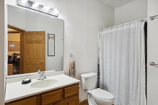 bathroom featuring vanity, curtained shower, and toilet