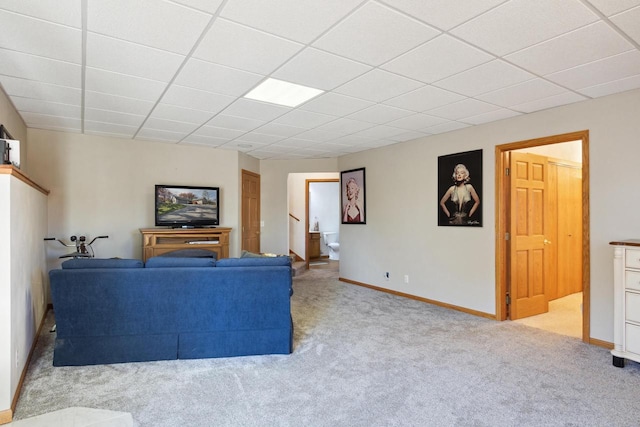 carpeted living room with a paneled ceiling