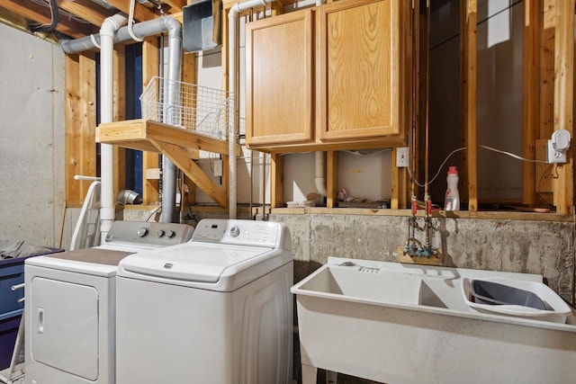 laundry room featuring cabinets and washer and dryer