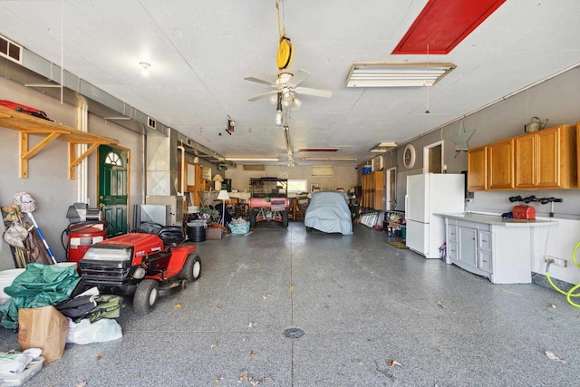 garage featuring ceiling fan and white refrigerator