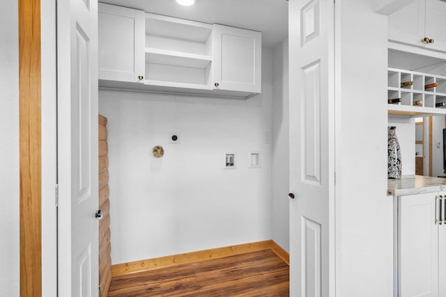 clothes washing area with hookup for an electric dryer, cabinets, hardwood / wood-style floors, and washer hookup