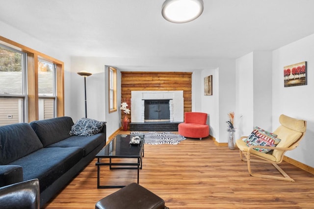 living room with wood-type flooring and a brick fireplace