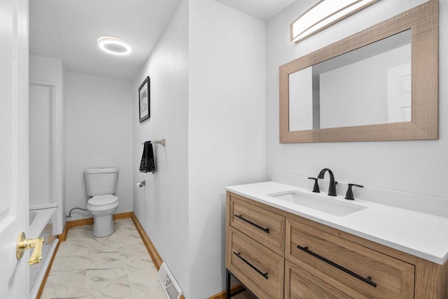 bathroom featuring vanity and toilet