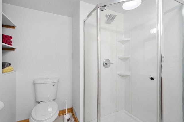 bathroom with a shower with door and toilet