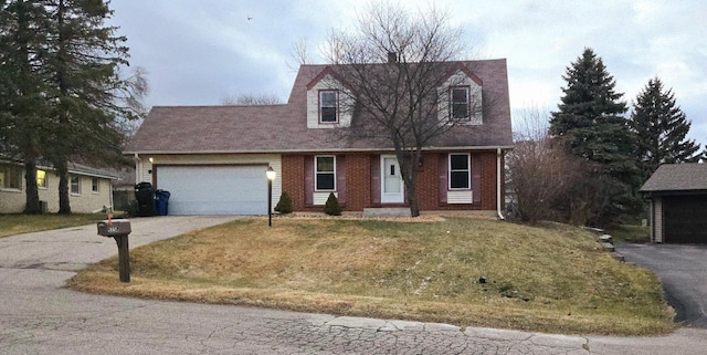 new england style home with a garage and a front yard