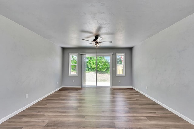 empty room featuring hardwood / wood-style flooring and ceiling fan