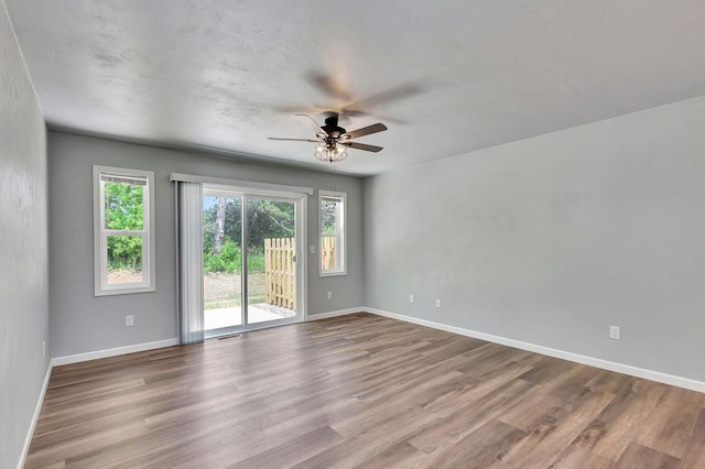 empty room featuring ceiling fan and light wood-type flooring