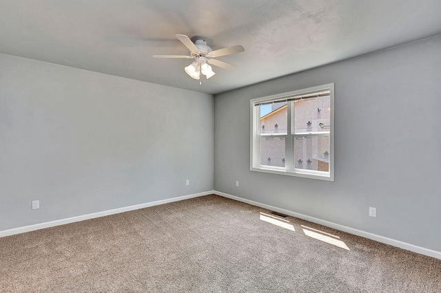 empty room with ceiling fan and carpet floors