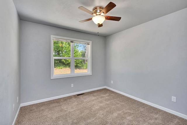 spare room featuring ceiling fan and carpet floors