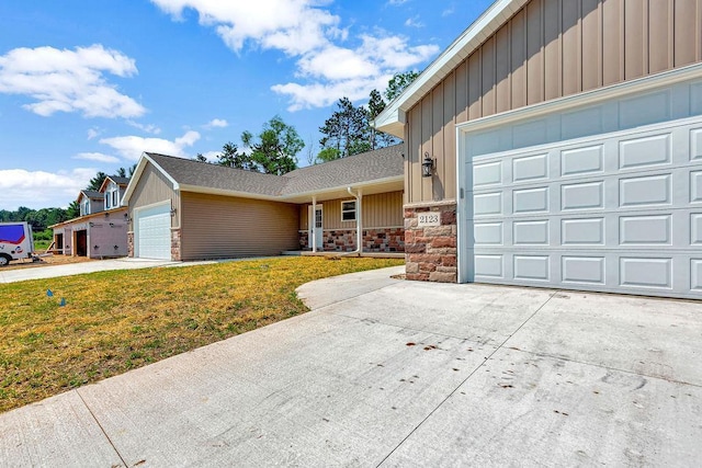 view of front of home featuring a garage and a front lawn