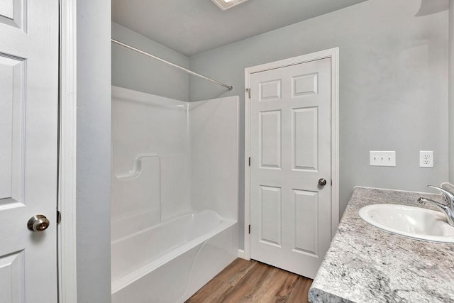 bathroom featuring vanity, wood-type flooring, and bathtub / shower combination