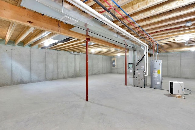 basement featuring heating unit, electric panel, and water heater