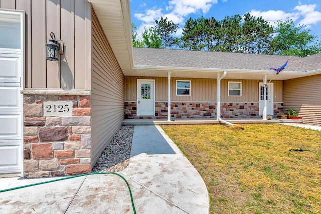 doorway to property with a lawn